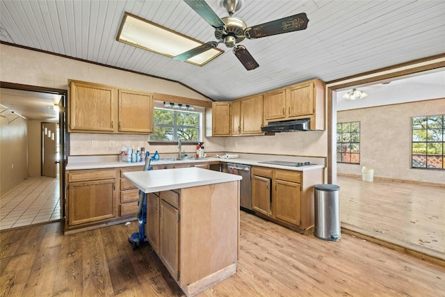 kitchen with lofted ceiling, light countertops, under cabinet range hood, dishwasher, and black electric stovetop