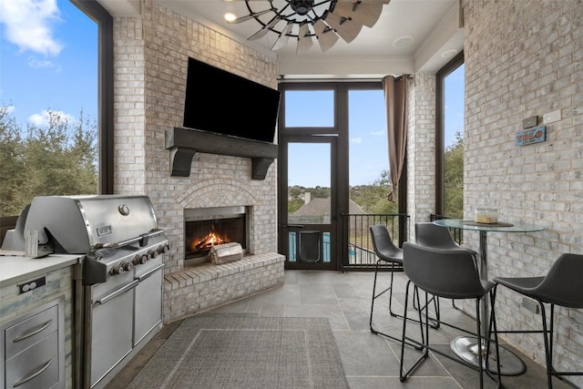 exterior space with a ceiling fan and an outdoor brick fireplace