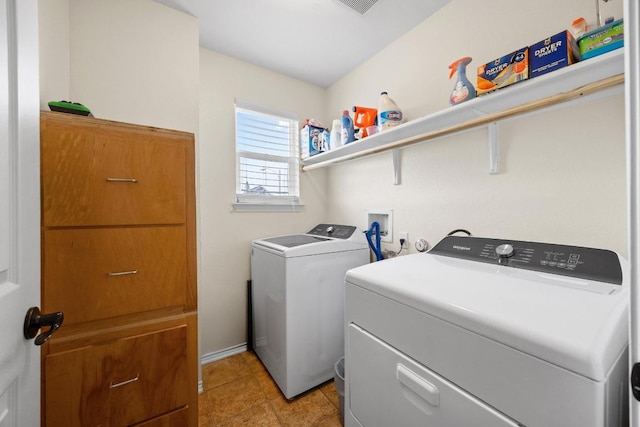 laundry room with laundry area, light tile patterned floors, and separate washer and dryer