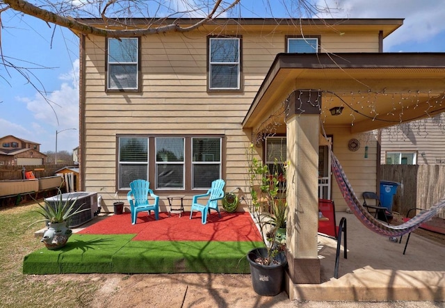 back of house with a patio, central AC unit, and fence