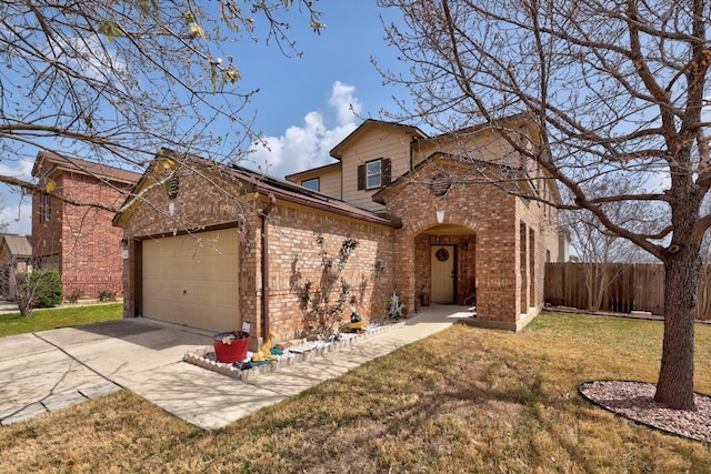 traditional-style house with fence, driveway, an attached garage, a front lawn, and brick siding