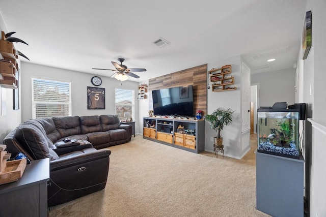 living room with visible vents, baseboards, ceiling fan, and carpet flooring