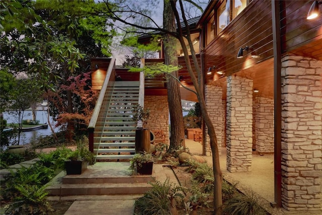 exterior space featuring stairway and stone siding