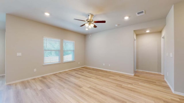 unfurnished room with visible vents, a ceiling fan, recessed lighting, light wood finished floors, and baseboards