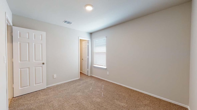 unfurnished bedroom featuring visible vents, baseboards, and carpet