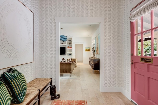 entrance foyer featuring wallpapered walls and light wood-style floors