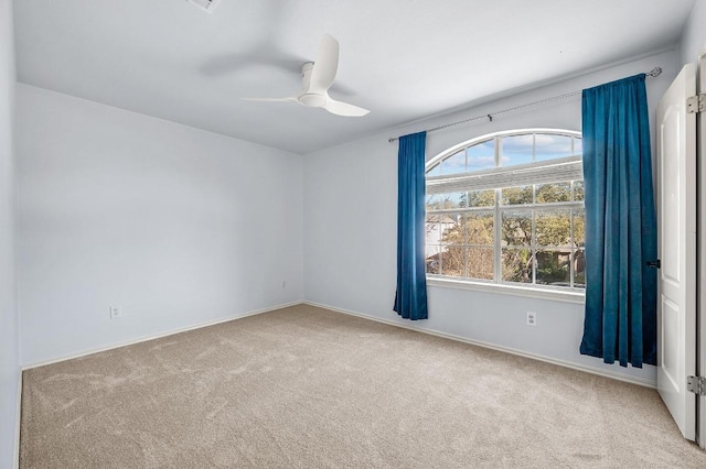 unfurnished room with carpet flooring and a ceiling fan