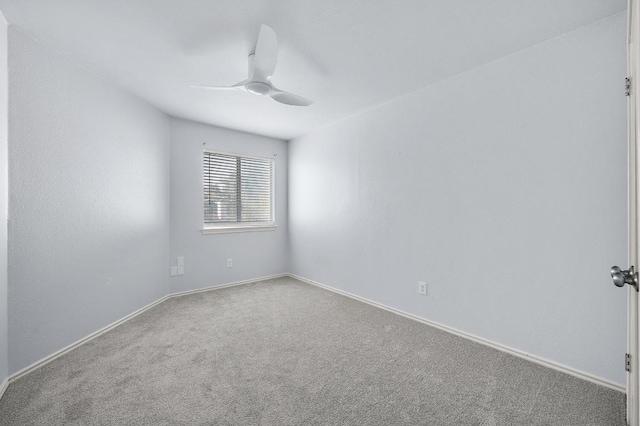 spare room with baseboards, carpet floors, and a ceiling fan