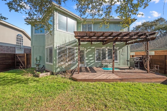 rear view of house with a wooden deck, fence, a pergola, and a lawn