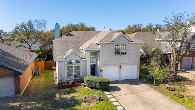 traditional-style home featuring cooling unit, fence, driveway, a garage, and brick siding