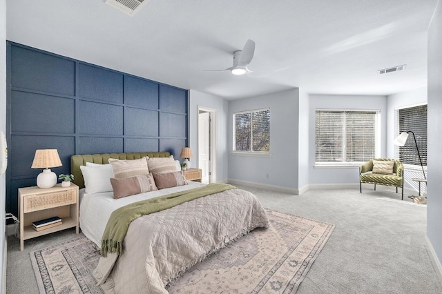 carpeted bedroom featuring visible vents, ceiling fan, and baseboards