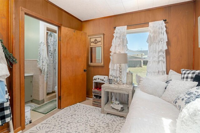living room featuring wooden walls and ornamental molding
