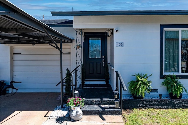 view of exterior entry featuring an attached garage