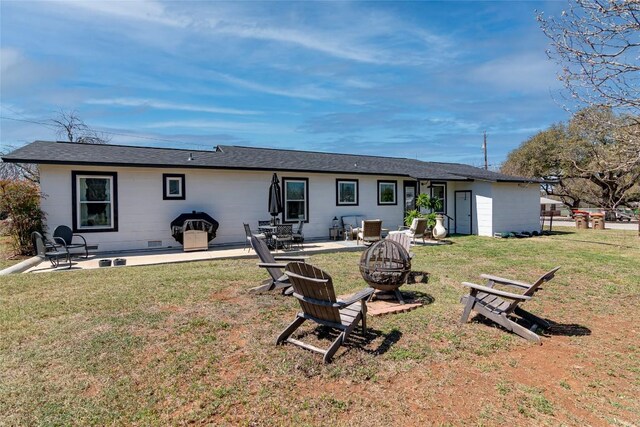 back of house featuring an outdoor fire pit, a yard, and a patio