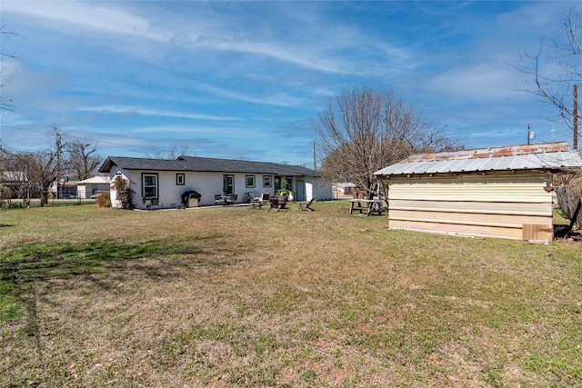 view of green lawn with an outbuilding