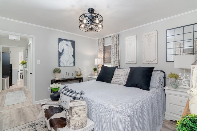 bedroom featuring crown molding, light wood-style flooring, a chandelier, and baseboards