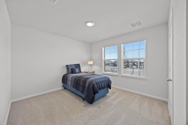 carpeted bedroom featuring visible vents and baseboards