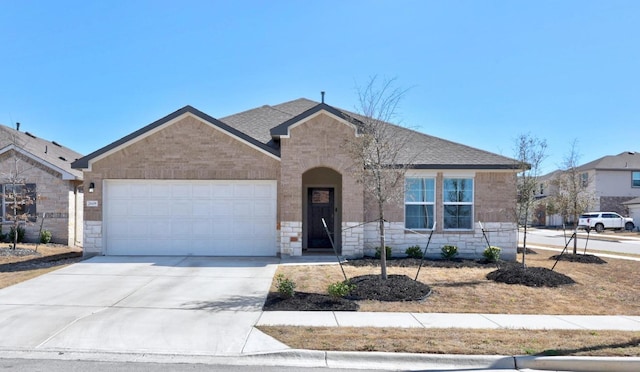 view of front of house featuring stone siding, driveway, an attached garage, and a shingled roof