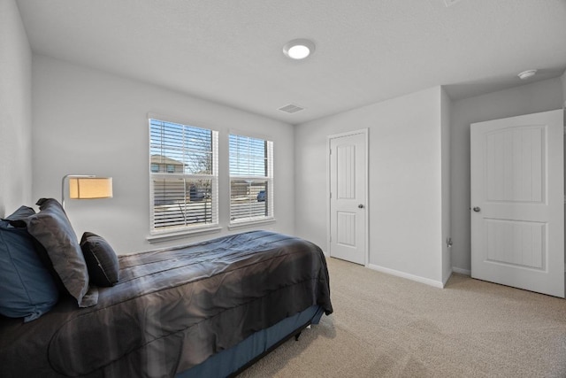 bedroom with visible vents, baseboards, and carpet flooring