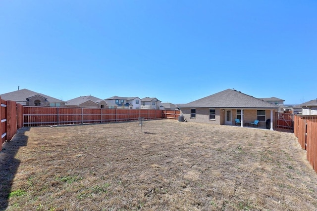 view of yard featuring a residential view and a fenced backyard