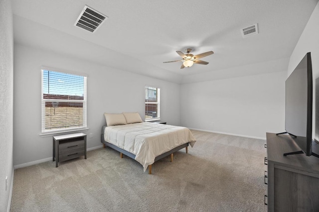 bedroom with visible vents, baseboards, and light colored carpet