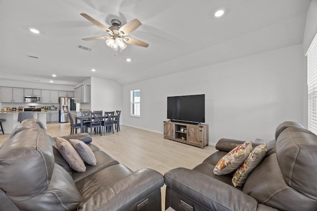 living room with visible vents, baseboards, ceiling fan, recessed lighting, and light wood-style floors