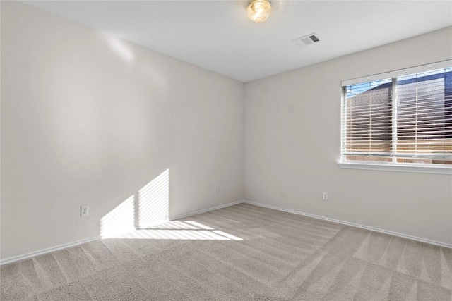 unfurnished room featuring baseboards, visible vents, and carpet floors