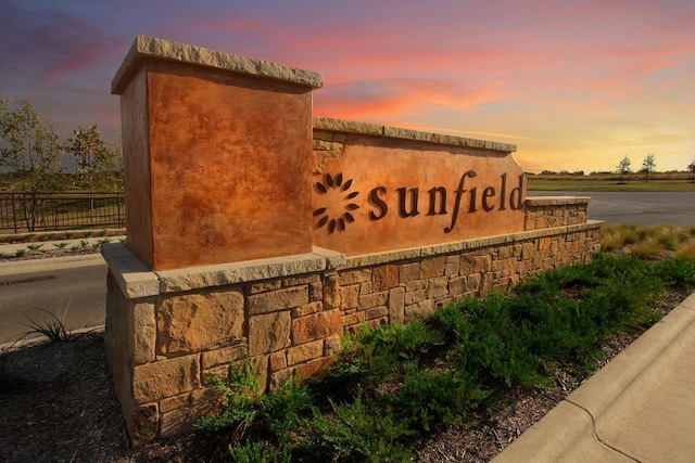 community / neighborhood sign featuring fence