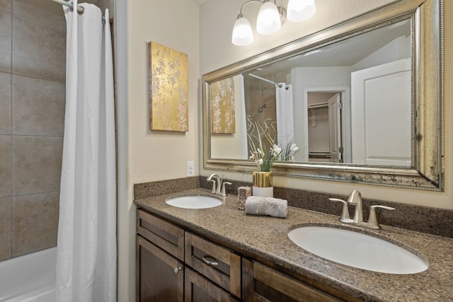 bathroom with double vanity, shower / bathtub combination with curtain, and a sink