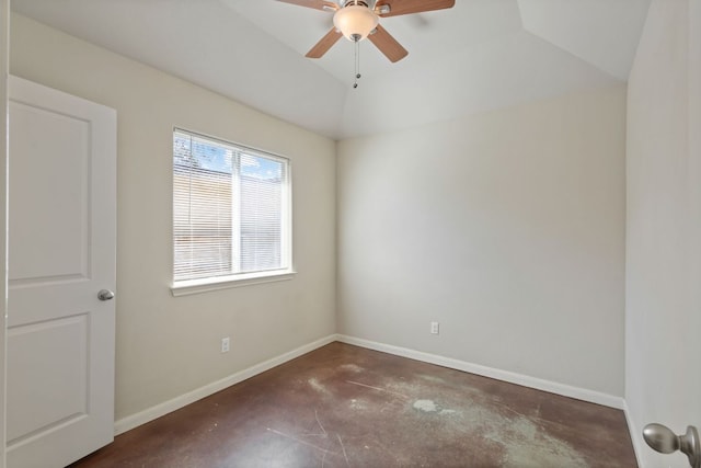 empty room with lofted ceiling, a ceiling fan, baseboards, and concrete floors