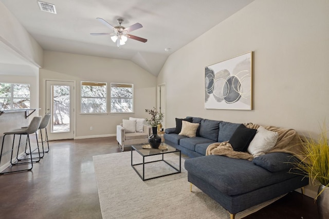 living room featuring a healthy amount of sunlight, visible vents, concrete floors, and baseboards