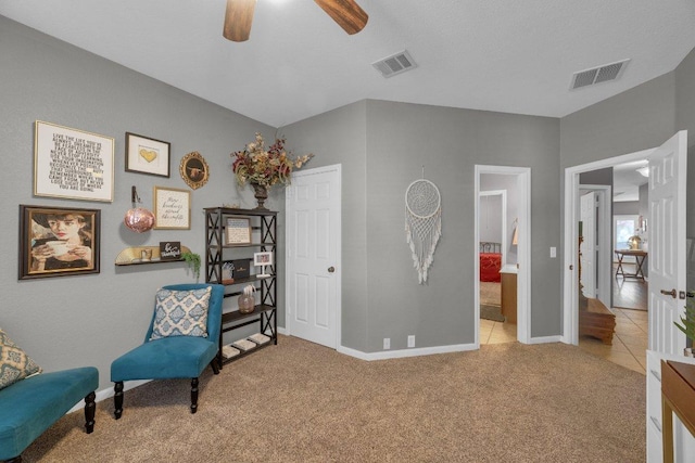 sitting room with visible vents, carpet floors, and baseboards