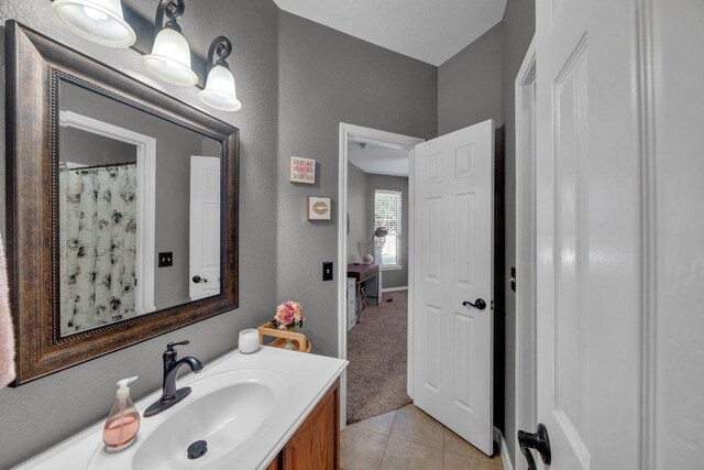 2157 Paradise Ridge Dr, Round Rock, TX 78665 - bathroom with vanity, tile patterned floors, and a textured wall