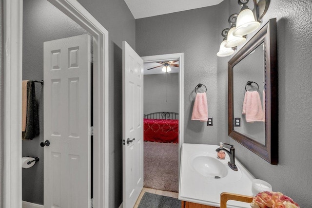 bathroom with vanity and a textured wall