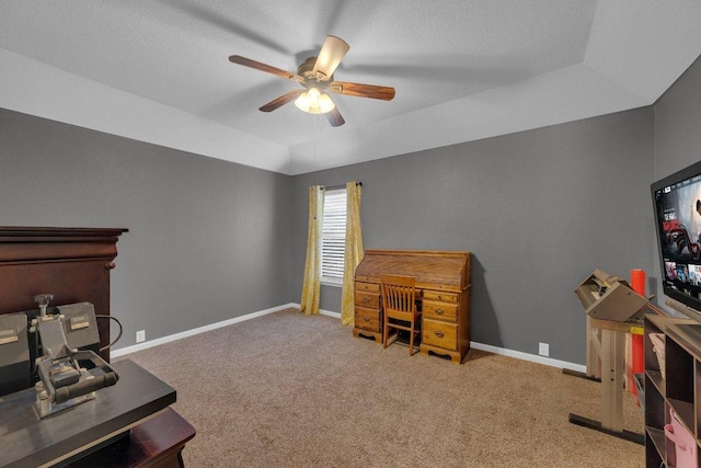 office space with baseboards, carpet, and a ceiling fan