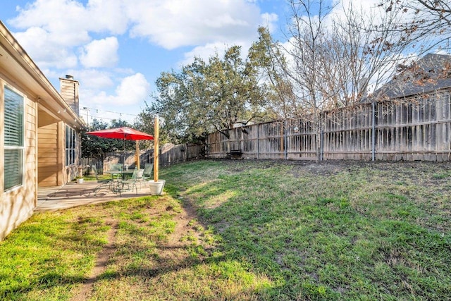 view of yard featuring a patio and a fenced backyard