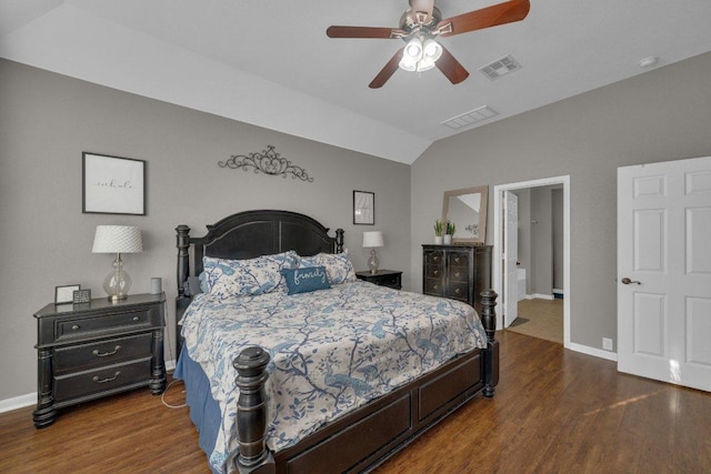 bedroom featuring visible vents, baseboards, lofted ceiling, and wood finished floors