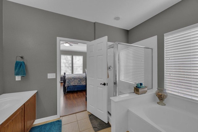 ensuite bathroom with vanity, ensuite bath, tile patterned flooring, a shower stall, and a garden tub