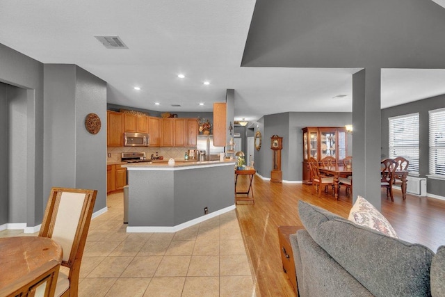2157 Paradise Ridge Dr, Round Rock, TX 78665 - kitchen with stainless steel appliances, baseboards, light countertops, decorative backsplash, and recessed lighting