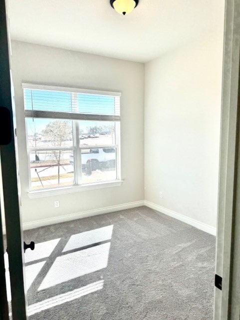 empty room with carpet flooring and baseboards