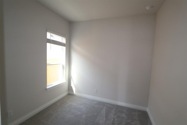 carpeted empty room with baseboards