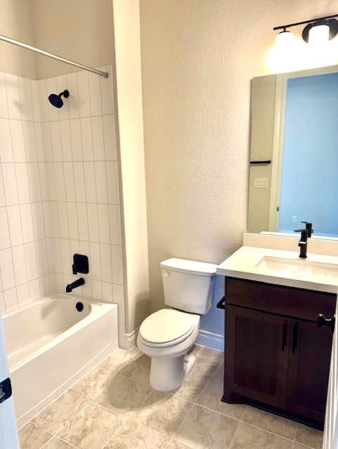 full bath with tile patterned floors, toilet, baseboards, bathing tub / shower combination, and vanity