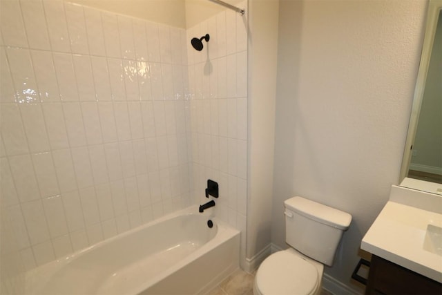 bathroom featuring tile patterned flooring, baseboards, toilet, bathtub / shower combination, and vanity