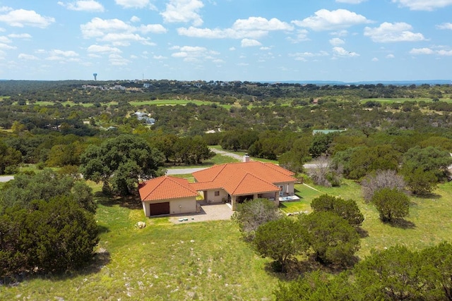 drone / aerial view featuring a forest view