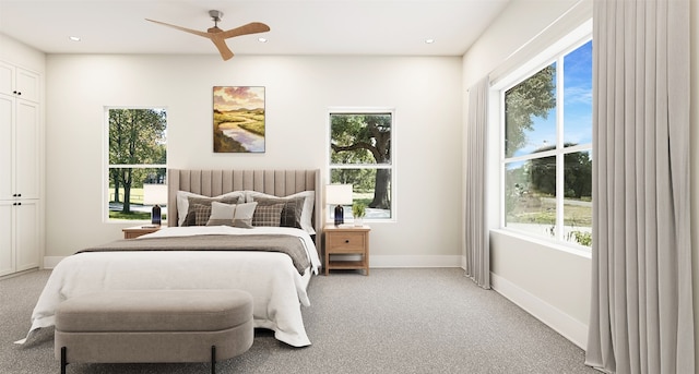 bedroom featuring multiple windows and light colored carpet