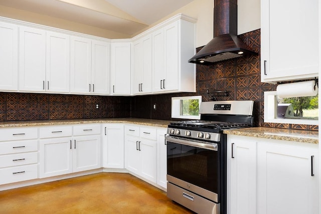 kitchen with decorative backsplash, wall chimney exhaust hood, white cabinetry, and stainless steel gas range