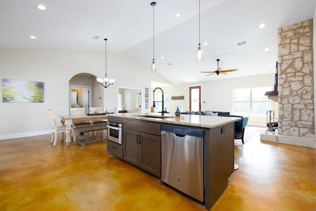 kitchen with a sink, hanging light fixtures, concrete flooring, appliances with stainless steel finishes, and open floor plan