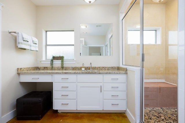 full bath with baseboards, concrete floors, a stall shower, and vanity