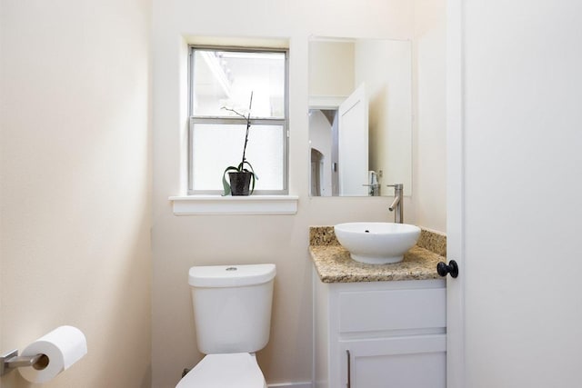 bathroom with toilet and vanity