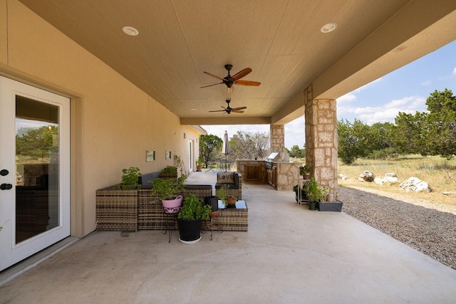 view of patio featuring an outdoor kitchen and ceiling fan